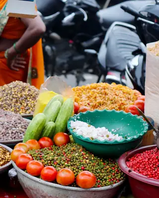 Bowls of chopped vegetables and chana at a chaat cart
